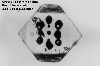 [Cyrstal of Ammonium Perchlorate showing occluded fluid]