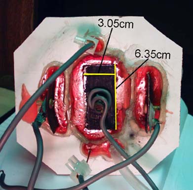 [Top of cell showing electrical connections]